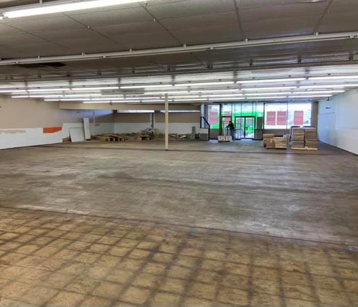 Empty storefront within a strip mall.  Room has been stripped down to the walls and floors.