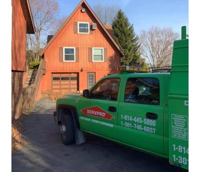 SERVPRO green truck parked outside a large vacation home